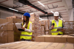 warehouse-workers-using-bar-code-scanner-and-tablet-and-checking-goods-inventory(1)